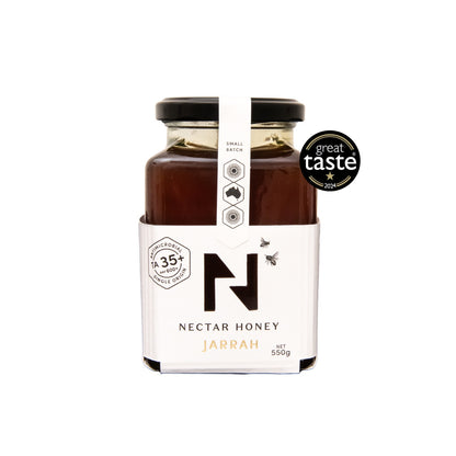 A jar of Jarrah honey from Nectar Honey with a label indicating it is raw, unprocessed, and has a Great Taste Award for 2024.