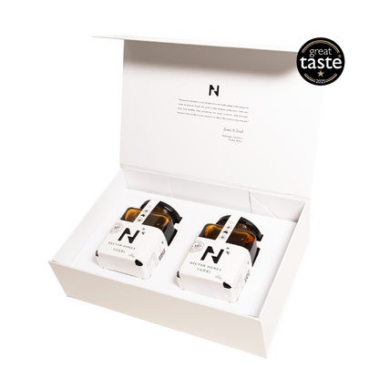 Two jars of honey in a white gift box with 'Great Taste' award logo.